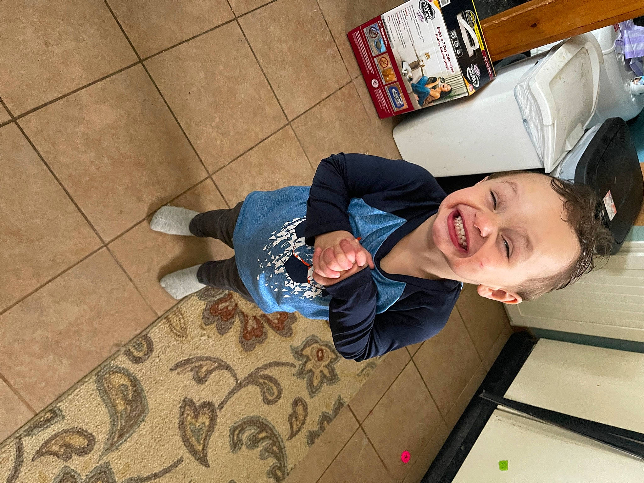 Mason is registered to the contest to win money with this photo: child, comfort, elbow, flooring, foot, fun, happy, hardwood, human_leg, joy, leisure, person, room, sitting, smile, toddler, wood