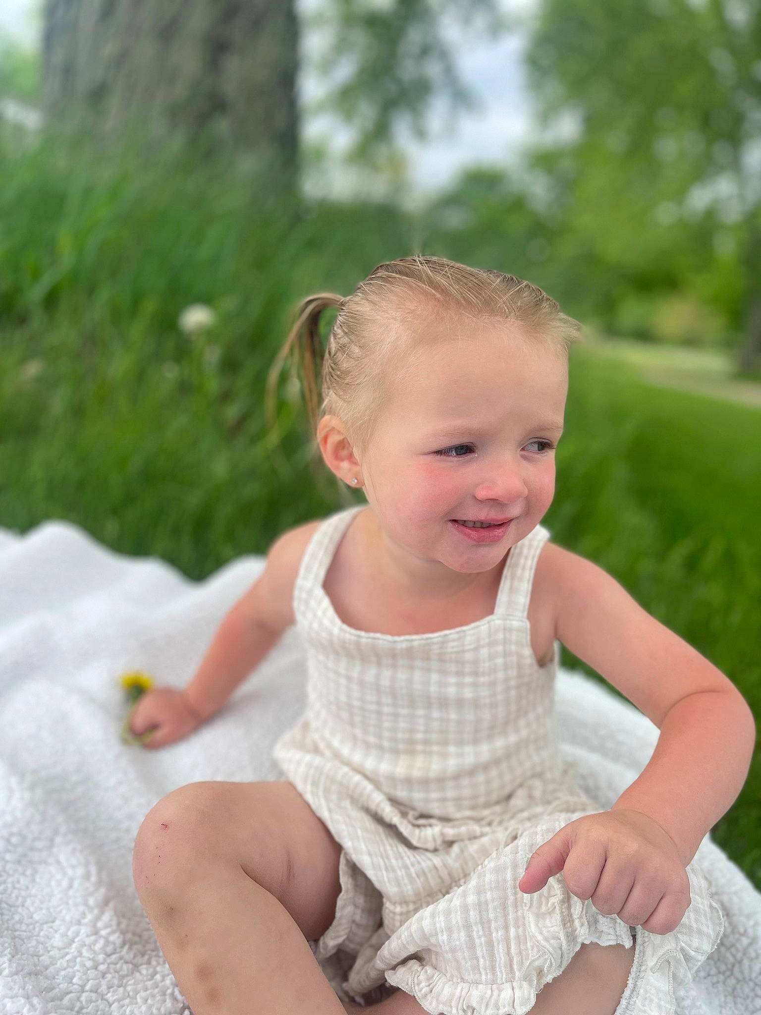 Oakley is registered to the contest to win money with this photo: baby, baby_toddler_clothing, child, dress, face, finger, flash_photography, fun, grass, happy, joy, leisure, people_in_nature, person, plant, recreation, sitting, skin, sleeve, smile
