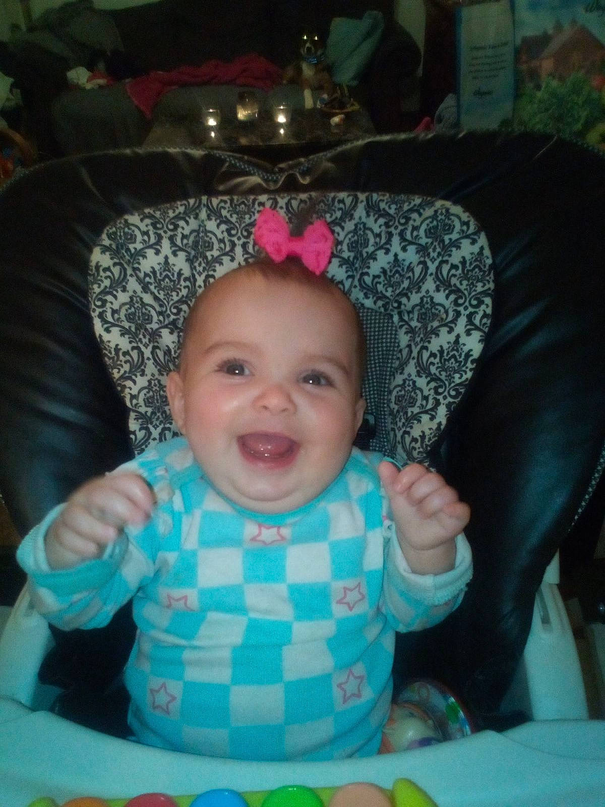 Elliana is registered to the contest to win money with this photo: baby, baby_carriage, baby_products, baby_toddler_clothing, cheek, child, comfort, costume_hat, couch, fashion_accessory, fun, happy, infant_bed, joy, person, pink, room, sitting, skin, smile