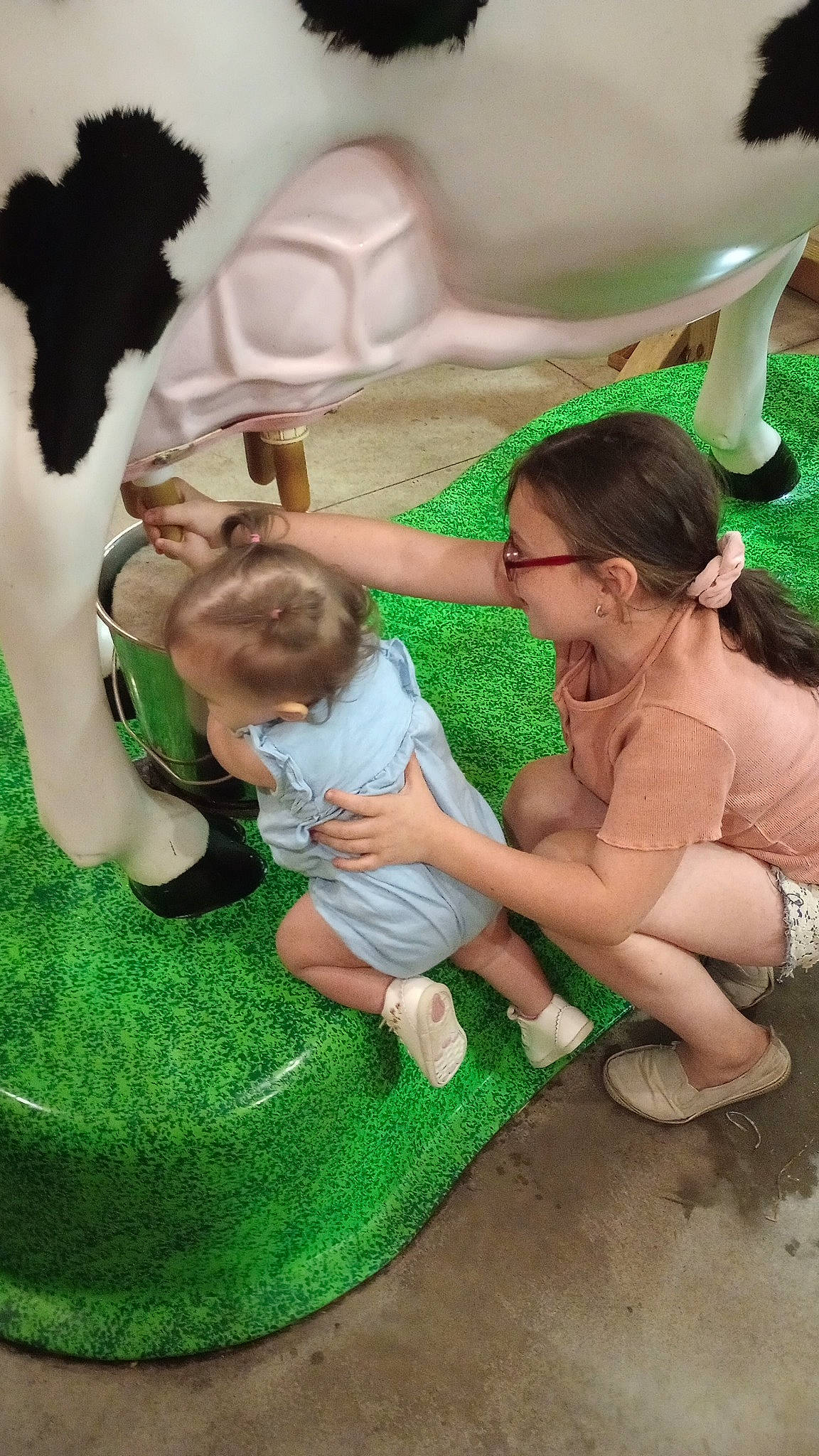 Olivia joined the competition — help win amazing prizes! baby, child, event, fun, gesture, grass, green, happy, head, interaction, leg, leisure, mammal, people_in_nature, person, plant, recreation, shorts, sitting, toddler