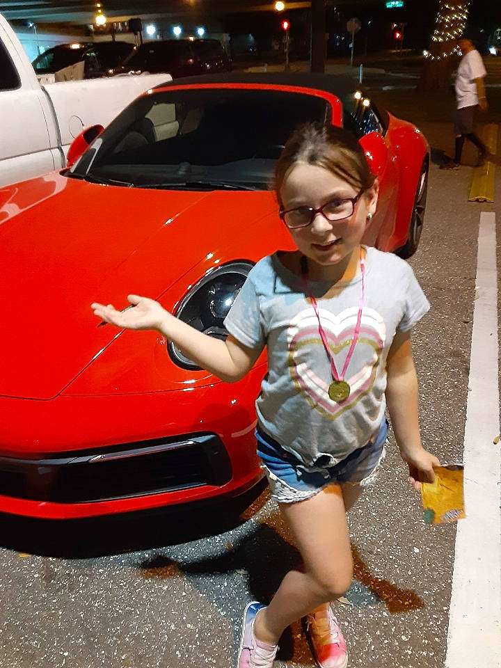 Olivia joined the competition — help win amazing prizes! automotive_design, automotive_exterior, automotive_lighting, beauty, bumper, car, event, fashion, hood, human_leg, land_vehicle, leg, motor_vehicle, person, personal_luxury_car, photograph, shorts, snapshot, thigh, under_exposed