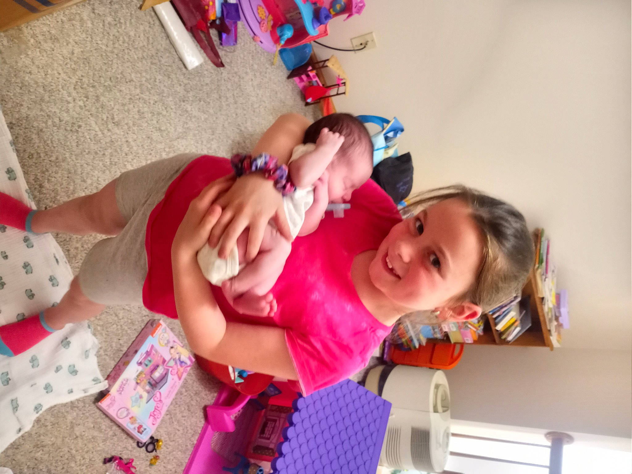 Olivia is registered to the contest to win money with this photo: abdomen, arm, baby, baby_toddler_clothing, child, event, foot, fun, happy, human_leg, jewellery, joy, leisure, party, pattern, person, play, room, smile, thigh