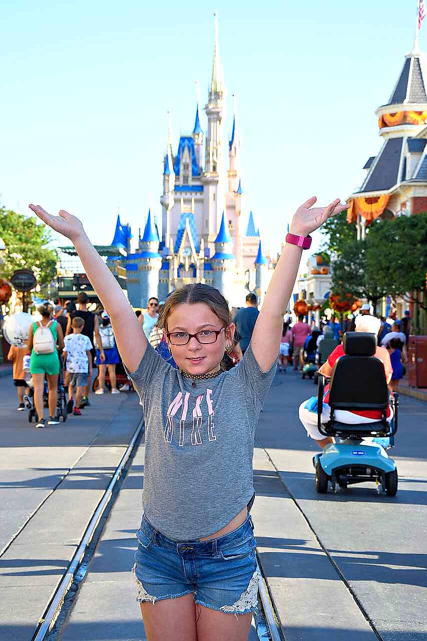 Olivia joined the competition — help win amazing prizes! blue, event, fun, happy, human_leg, leisure, nonbuilding_structure, person, recreation, shorts, sky, spire, summer, t_shirt, thigh, tourism, travel, turret, vacation, walt_disney_world