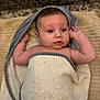 Jade a rejoint le concours — aidez-le/la à gagner de superbes lots ! baby, towel, infant, wrapped, blanket, skin, face, arm, blue_eyes, head, expression, curious, lying_down, soft_texture, indoors, child, newborn, person, patterned_background, comfort