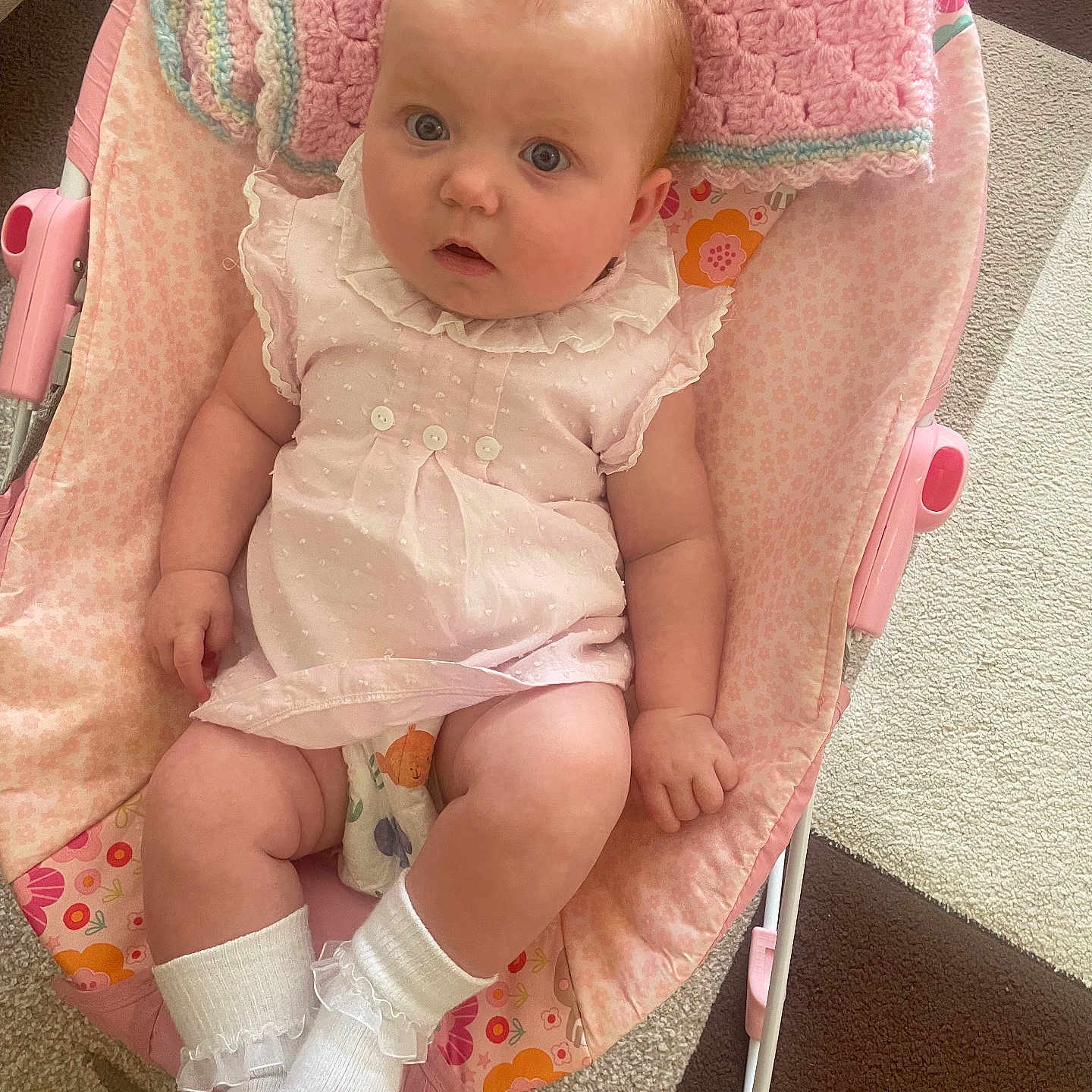 Lucy-Belle is registered to the contest to win money with this photo: baby, baby_chair, blanket, carpet, carpet_pattern, child, comfort, curious, cute, dress, floor, indoor, infant, person, pink, portrait, resting, socks, soft_toys, young_child