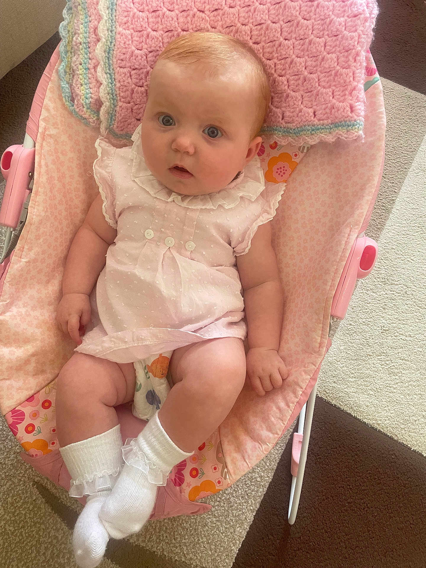 Lucy-Belle is registered to the contest to win money with this photo: baby, infant, child, pink, dress, socks, blanket, baby_chair, carpet, indoor, cute, portrait, person, soft_toys, comfort, floor, carpet_pattern, resting, young_child, curious