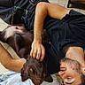 Ban participe au concours pour gagner de l'argent avec cette photo : affection, beard, black_tshirt, brown_dog, casual_clothing, dog, floor, human_animal_interaction, indoor, lying_down, man, paw, petting, relaxed, resting, short_hair, skin, tile, tiled_floor, towel