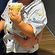 Luka joined the competition — help win amazing prizes! adult, child, cupcake, expression, face, floor, food, frosting, hand, holding, indoor, light, person, sandals, shadow, shirt, shorts, standing, tattoo, toddler