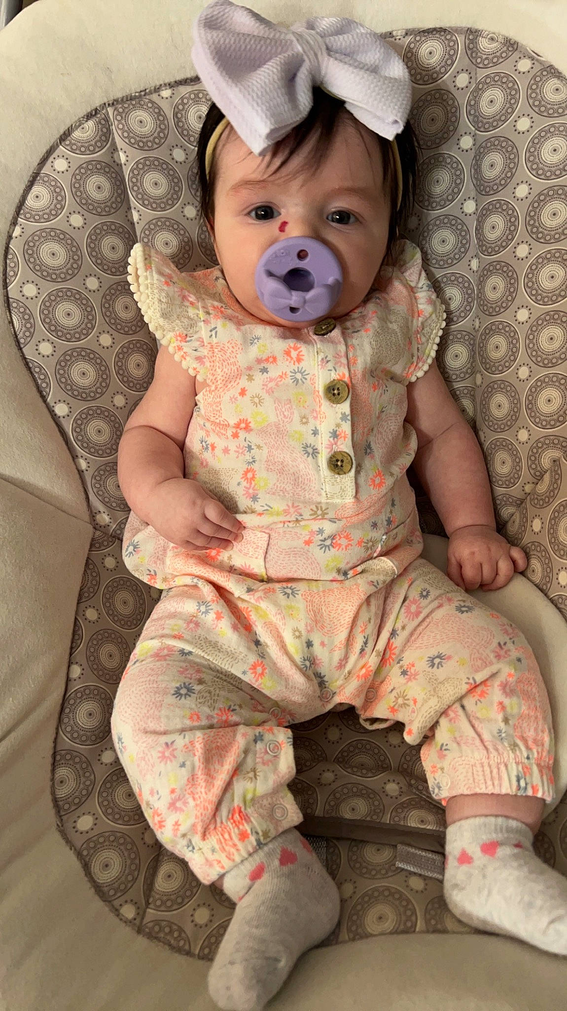 Alaina is registered to the contest to win money with this photo: baby, baby_products, baby_toddler_clothing, cap, cheek, child, comfort, eye, face, fashion_accessory, head, iris, linens, pattern, person, pink, sitting, skin, sleeve, smile