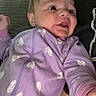 Wrenlee is registered to the contest to win money with this photo: baby, infant, child, portrait, indoor, sitting, lying_down, lavender, onesie, hearts, wide_eyed, face, person, adult, lap, cushion, sofa, clothing, cozy, candid