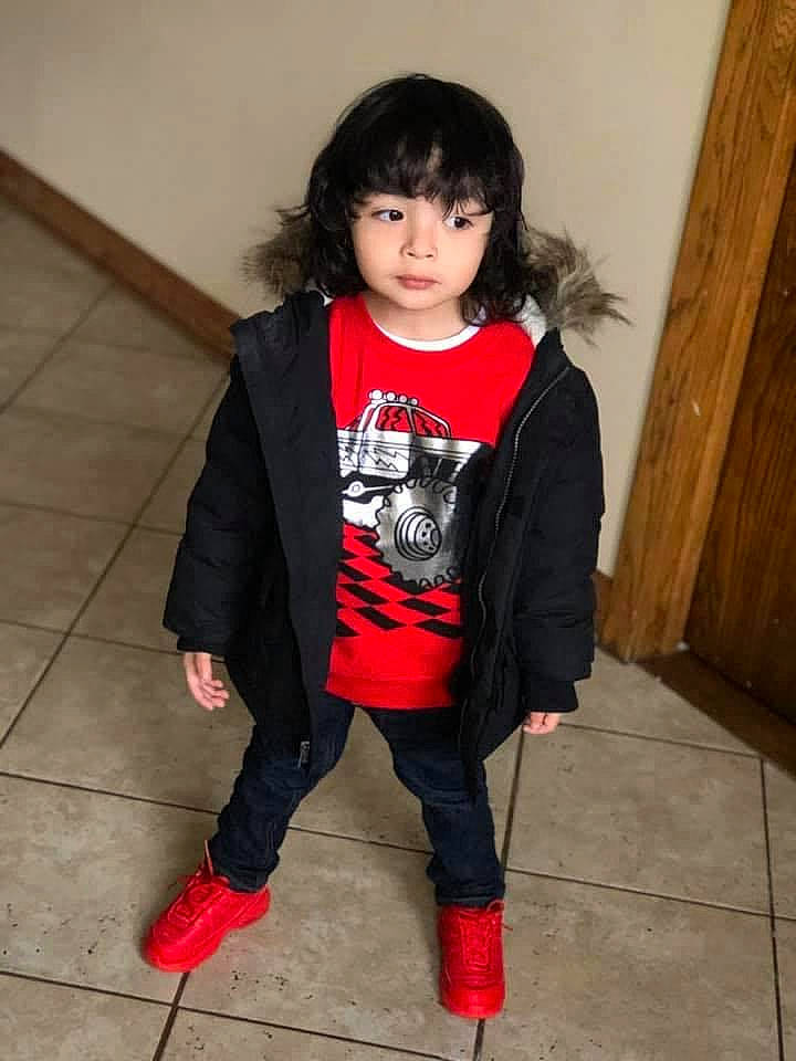 Sebastian is registered to the contest to win money with this photo: child, child_model, clothing, footwear, jacket, leather_jacket, leg, outerwear, person, shoe, sleeve, snapshot, standing, tights, trousers