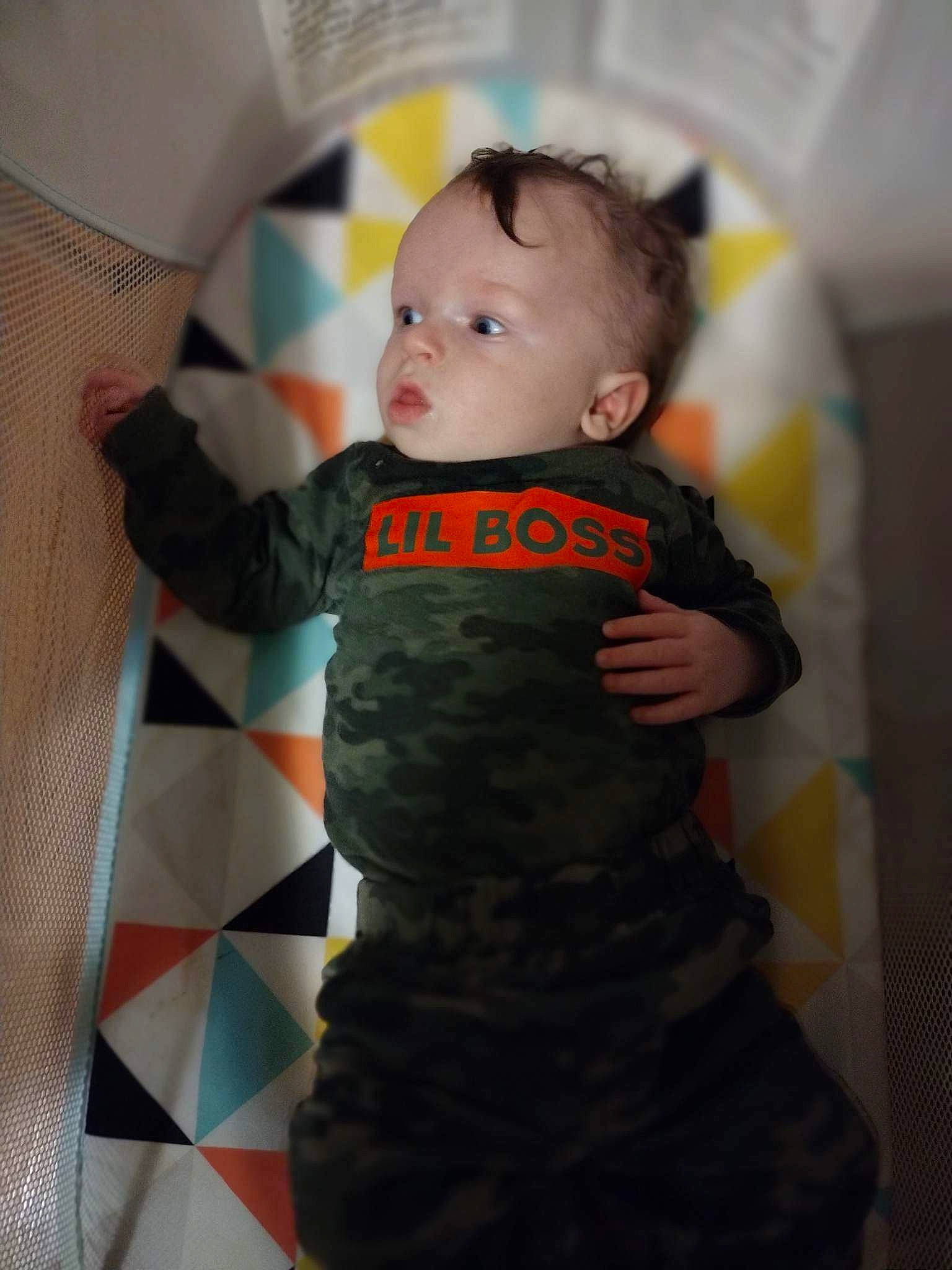 Percy is registered to the contest to win money with this photo: baby, baby_products, baby_toddler_clothing, child, comfort, elbow, finger, flooring, linens, pattern, person, room, sitting, sleeve, sock, t_shirt, toddler