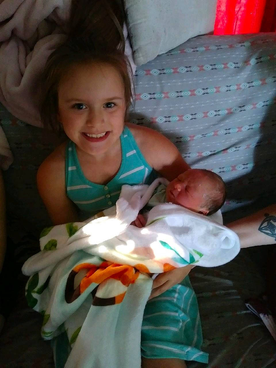 Arianna joined the competition — help win amazing prizes! arm, baby, baby_toddler_clothing, child, comfort, couch, event, face, finger, fun, gesture, happy, head, joy, lap, mouth, person, skin, smile, t_shirt