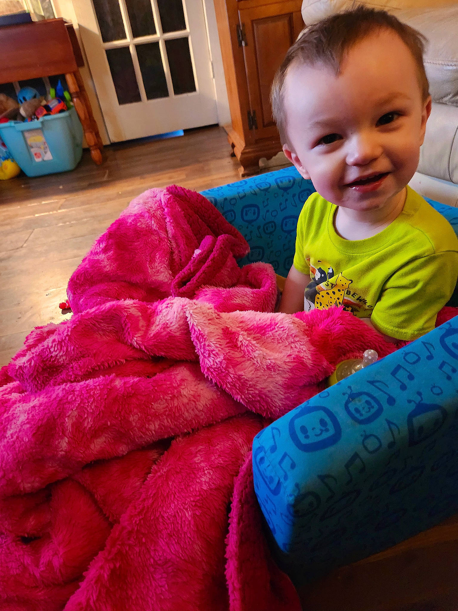 Wyatt is registered to the contest to win money with this photo: baby_toddler_clothing, blue, cabinetry, child, cupboard, finger, flooring, hand, happy, head, joy, magenta, person, pink, purple, room, skin, sleeve, smile, t_shirt