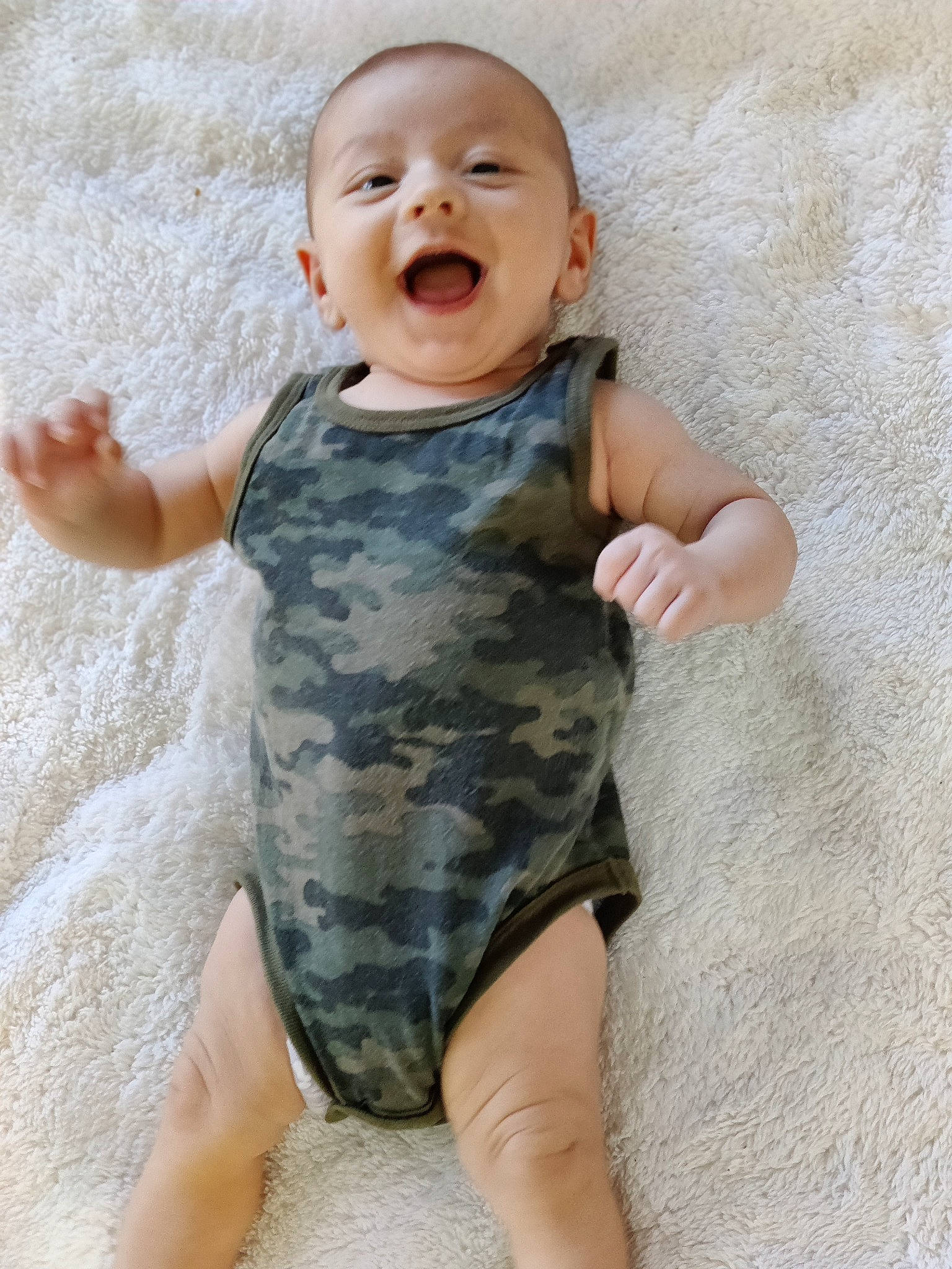 Jonah is registered to the contest to win money with this photo: arm, baby, baby_toddler_clothing, comfort, finger, gesture, hand, happy, human_body, neck, nose, pattern, person, skin, sleeve, smile, stomach, t_shirt, thigh, thumb