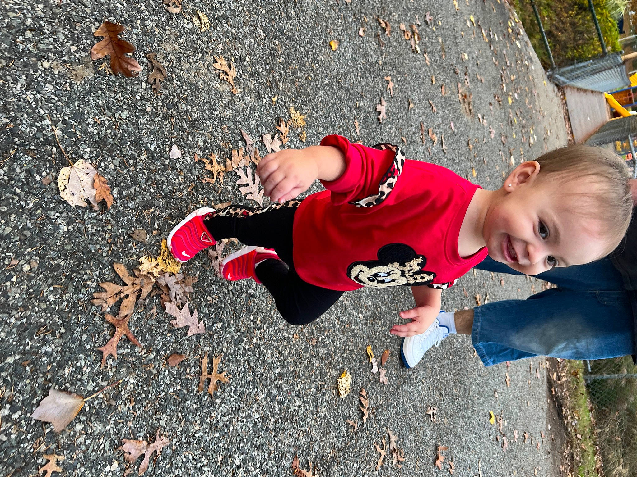 Mia is registered to the contest to win money with this photo: asphalt, carmine, child, concrete, fun, grass, happy, human_leg, joy, leaf, leg, leisure, people_in_nature, person, recreation, road_surface, shadow, sidewalk, sneakers, soil