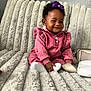Akiyra is registered to the contest to win money with this photo: baby, child, couch, cozy, cute, fluffy, furniture, girl, happy, home, indoor, infant, person, pink_outfit, portrait, purple_bow, seated, smile, socks, texture