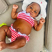 Akiyra joined the competition — help win amazing prizes! baby, bikini, child, couch, cute, face, furniture, hat, infant, lying_down, outdoor, person, red_stripes, relaxing, skin, sofa, striped_clothing, summer, sunhat, white_hat