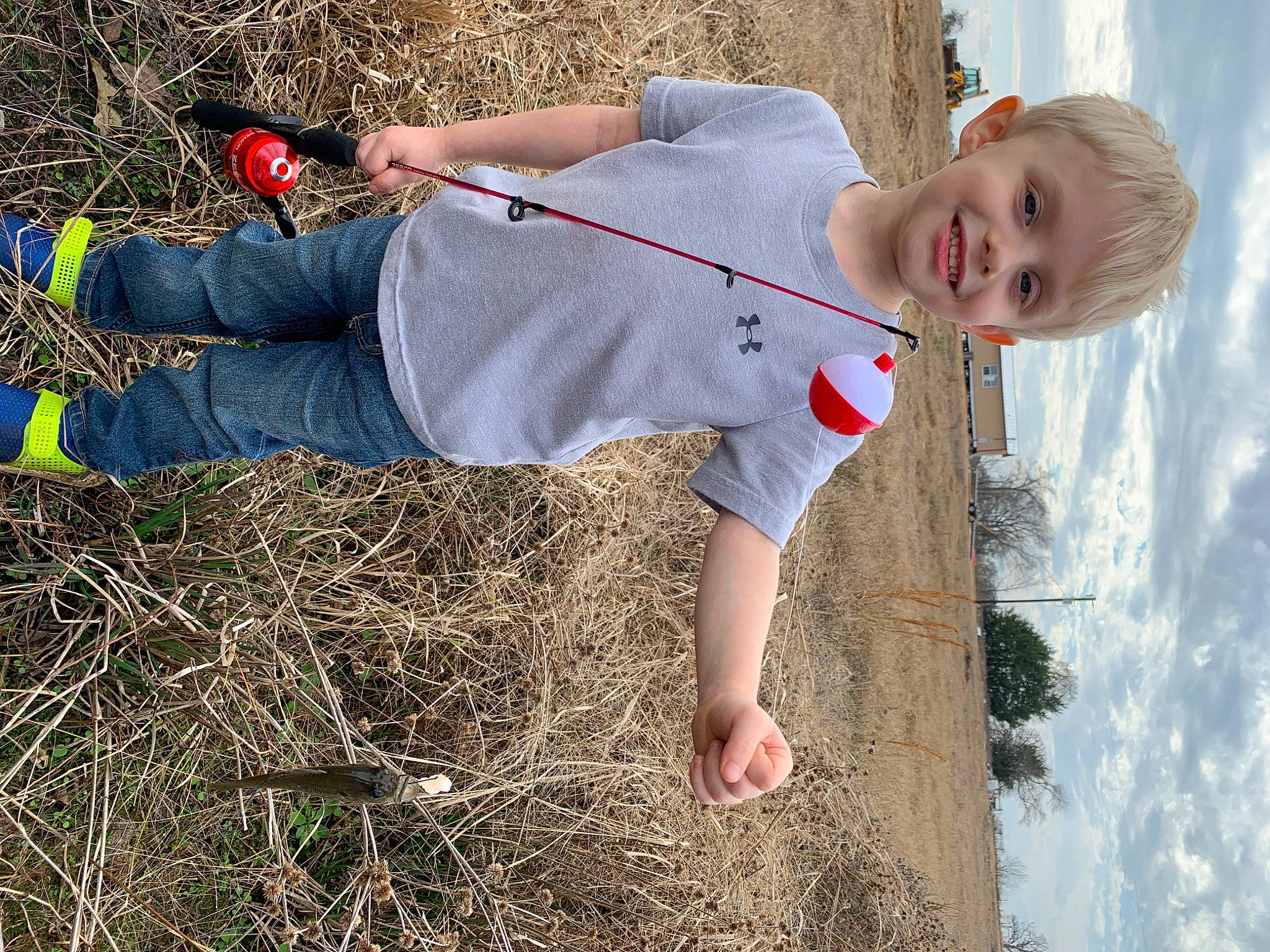 Carter is registered to the contest to win money with this photo: baby_toddler_clothing, child, fun, grass, grass_family, happy, joy, leisure, people_in_nature, person, play, recreation, shadow, sky, smile, soil, t_shirt, toddler, tree