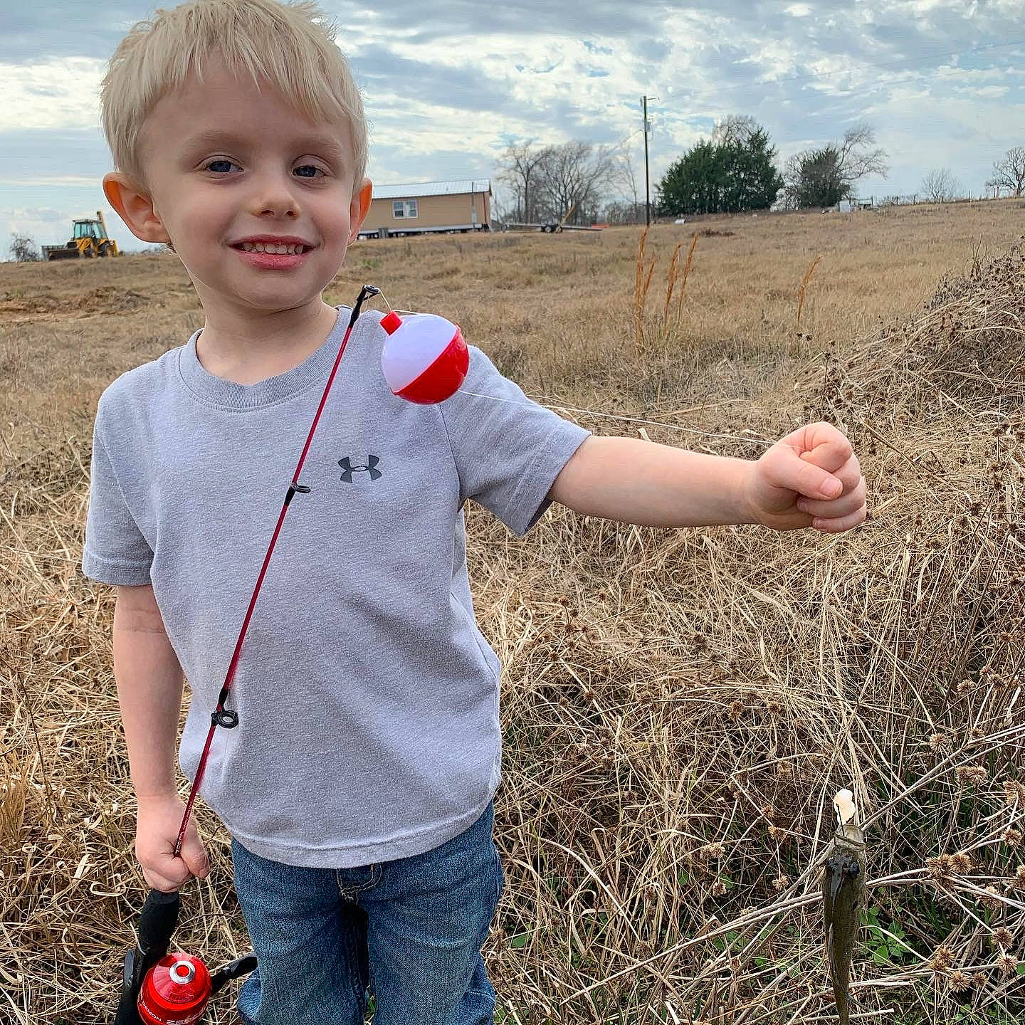 Carter is registered to the contest to win money with this photo: agriculture, baby_toddler_clothing, cloud, finger, fun, gesture, grass, grass_family, grassland, happy, jeans, joy, landscape, meadow, people_in_nature, person, plant, prairie, sky, sleeve