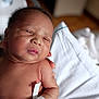 newborn, baby, infant, hospital, wristband, skin, face, hand, person, portrait, hospital_bed, blanket, care, newborn_baby, closeup, human, child, sleepy, hospital_room, medical