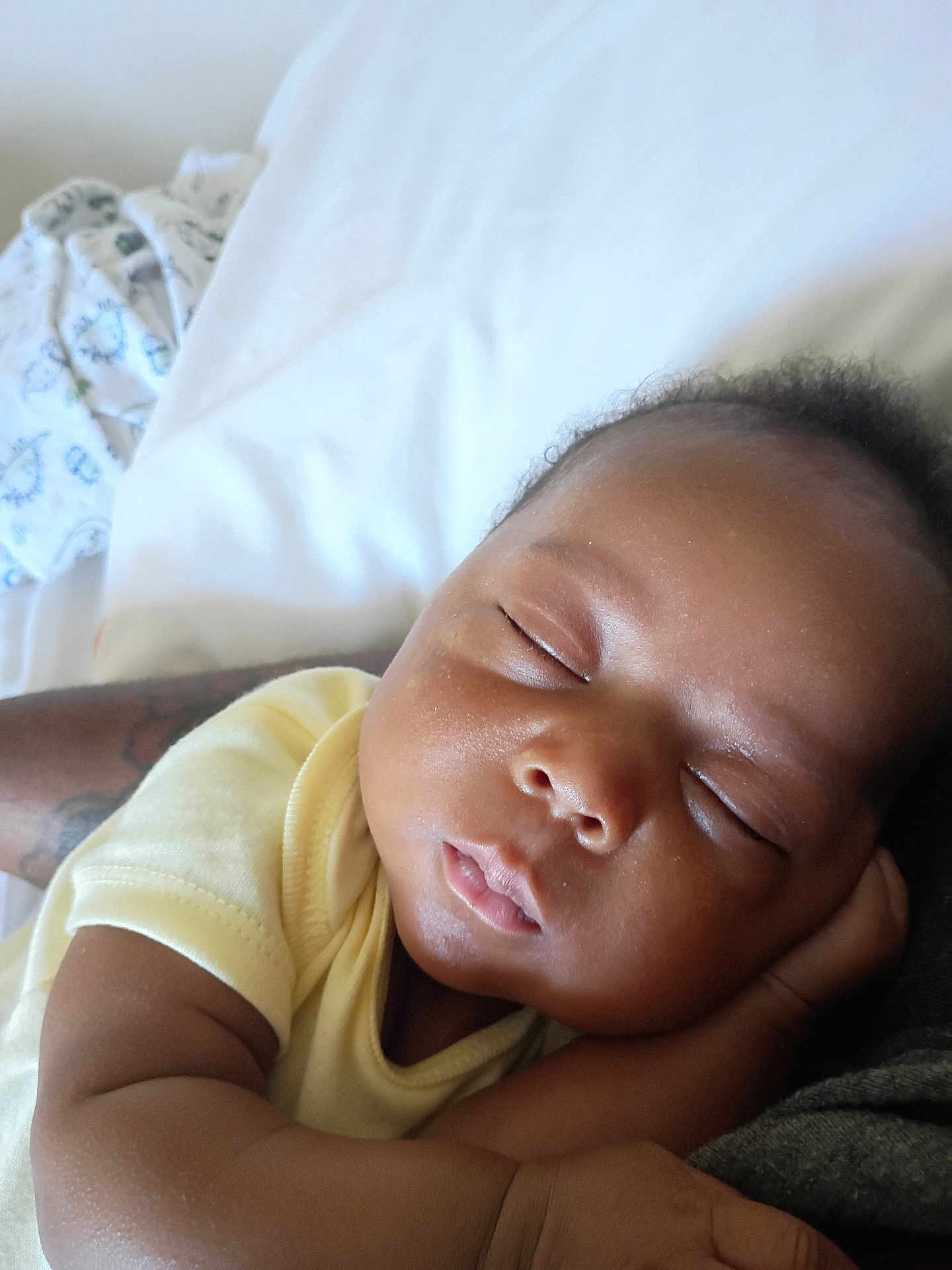Bodhi joined the competition — help win amazing prizes! baby, sleeping, infant, face, skin, arm, yellow_clothing, rest, peaceful, closeup, portrait, child, newborn, soft, comfort, lying_down, toddler, relaxation, hand, indoors