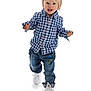toddler, child, blonde_hair, blue_checkered_shirt, jeans, dinosaur_patch, white_sneakers, walking, studio_photo, white_background, happy, curious, full_body, casual_clothing, cute, portrait, active, young_child, fashion, smiling