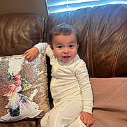 Ronan joined the competition — help win amazing prizes! baby, child, infant, portrait, sitting, couch, sofa, pajamas, stars, smiling, happy, indoor, window, blinds, pillow, sequins, sparkly, home, furniture, photography