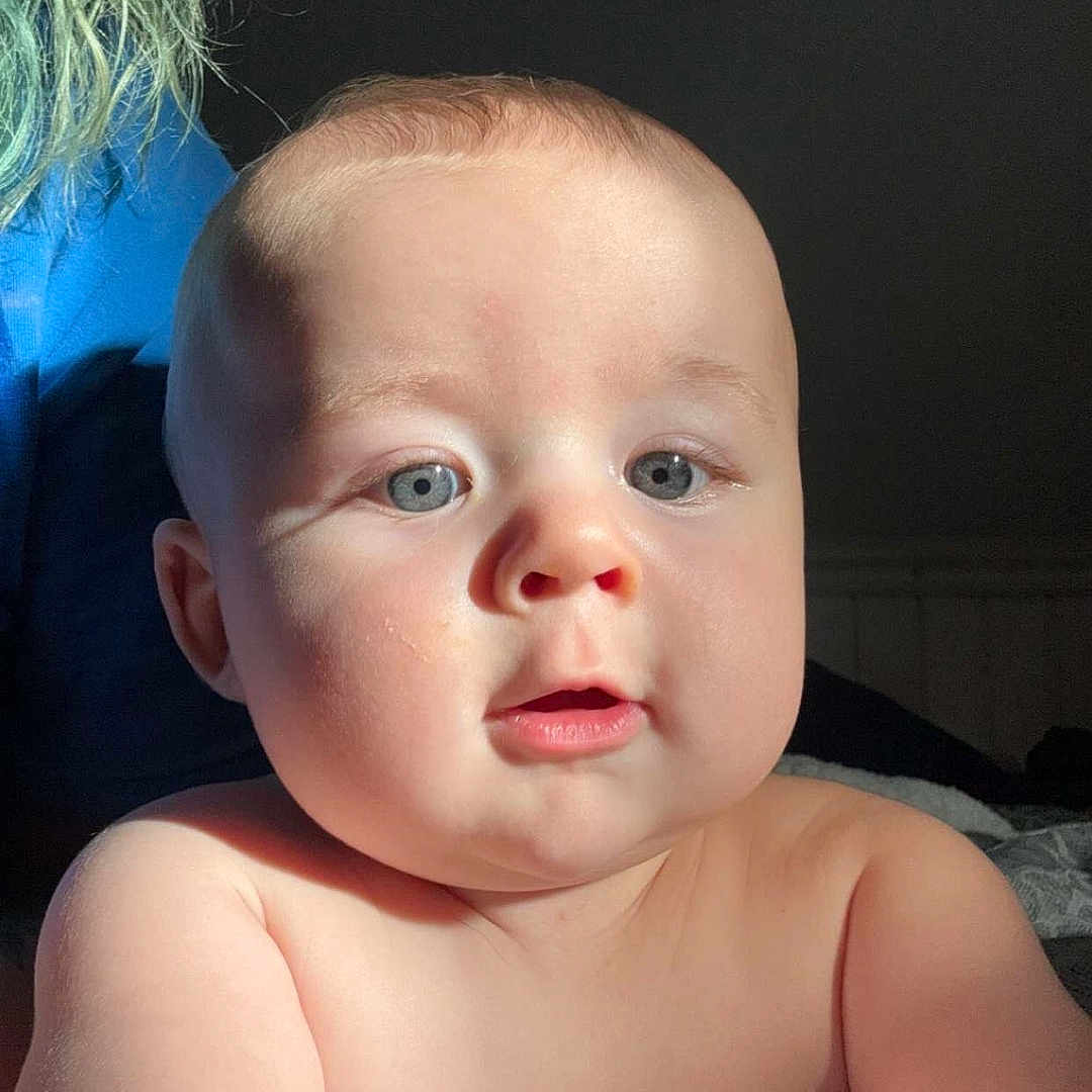 Waylon joined the competition — help win amazing prizes! baby, bed, bedroom, blonde, bodypart, face, furniture, happy, head, indoors, mouth, newborn, person, photography, portrait, quilt, room, selfie, sitting, smile