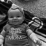 Isabella joined the competition — help win amazing prizes! baby, infant, smiling, headband, bow, onesie, text_on_clothing, carpet, blanket, pattern, cute, chubby_arms, happy, indoor, person, child, lying_down, black_and_white, closeup, portrait