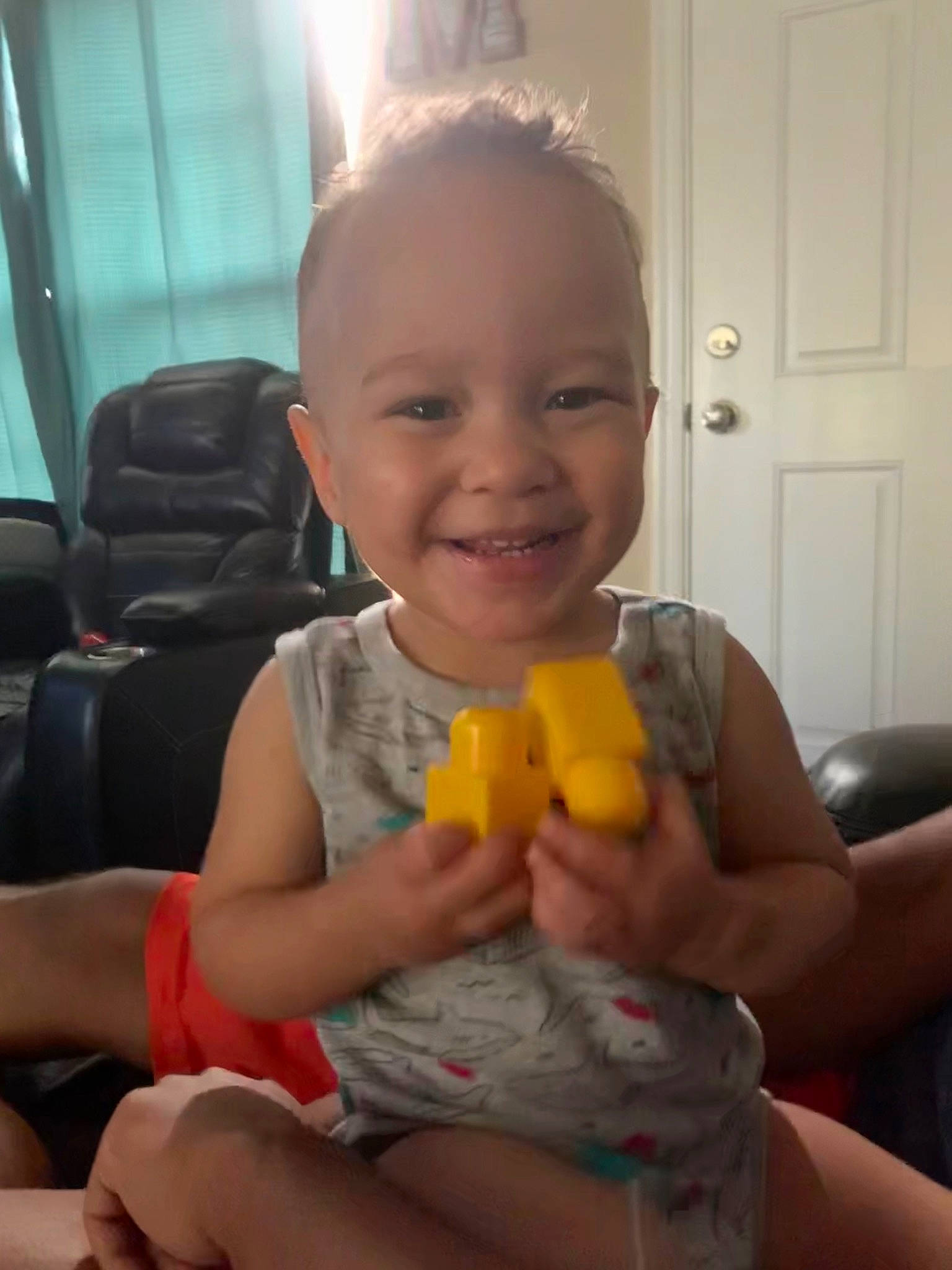 Kashen is registered to the contest to win money with this photo: baby, child, finger, fun, hand, joy, person, play, sitting, skin, thumb, toddler, toy, yellow