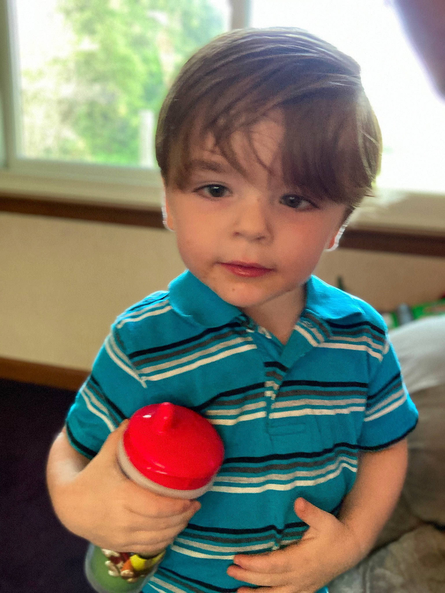 Cooper is registered to the contest to win money with this photo: baby_playing_with_toys, baby_toddler_clothing, cheek, child, electric_blue, face, finger, fun, gesture, happy, musical_instrument, party_supply, person, shirt, skin, sleeve, smile, t_shirt, thumb, toddler