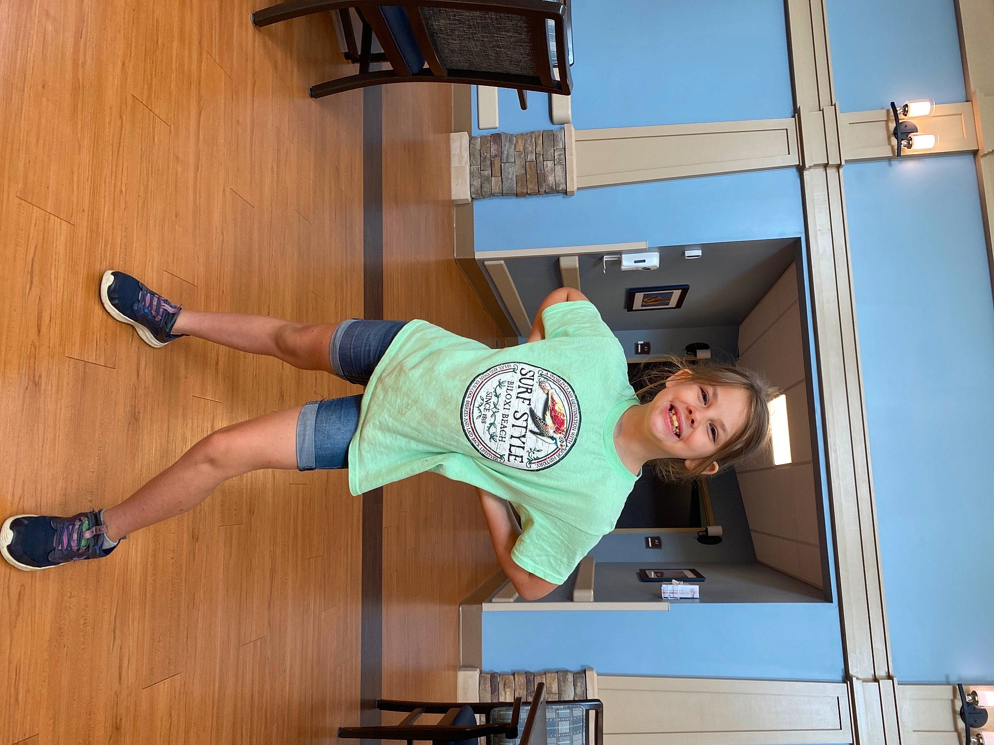 Ava-grace is registered to the contest to win money with this photo: balance, calf, flooring, fun, hardwood, human_leg, joy, knee, leisure, outdoor_shoe, person, room, shorts, smile, sock, sportswear, t_shirt, thigh, varnish, walking_shoe