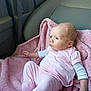 baby, infant, pink_clothing, blanket, car_seat, child, cute, indoors, portrait, newborn, soft_texture, clothing, seat, person, young_child, human, resting, casual, cozy, curious