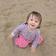 Charlee-Jo joined the competition — help win amazing prizes! toddler, child, sand, outdoor, happy, smiling, blue_eyes, pink_pants, patterned_shirt, sitting, playful, hair, face, casual_clothing, nature, young_child, cute, joyful, baby, portrait