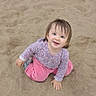 toddler, child, sand, outdoor, happy, smiling, blue_eyes, pink_pants, patterned_shirt, sitting, playful, hair, face, casual_clothing, nature, young_child, cute, joyful, baby, portrait