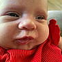 baby, closeup, face, infant, red_clothing, cheeks, skin, portrait, cute, child, expression, indoor, human, young, person, clothing, soft_light, head, eyes, mouth