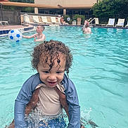 Camari joined the competition — help win amazing prizes! child, toddler, pool, water, swimming, splash, curly_hair, blue_ball, adult, outdoor, fun, summer, playing, happy, person, water_sport, leisure, family, recreation, vacation
