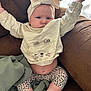 baby, infant, child, headband, bow, sweater, cat_face, leopard_print, leggings, socks, couch, blanket, furniture, indoors, person, cute, chubby, stretching, expression, portrait