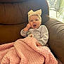 Xanova is registered to the contest to win money with this photo: baby, child, blanket, pink_blanket, headband, bow, armchair, brown_armchair, indoors, cute, expression, face, clothing, pacifier_clip, person, seated, cozy, soft_texture, window, daylight