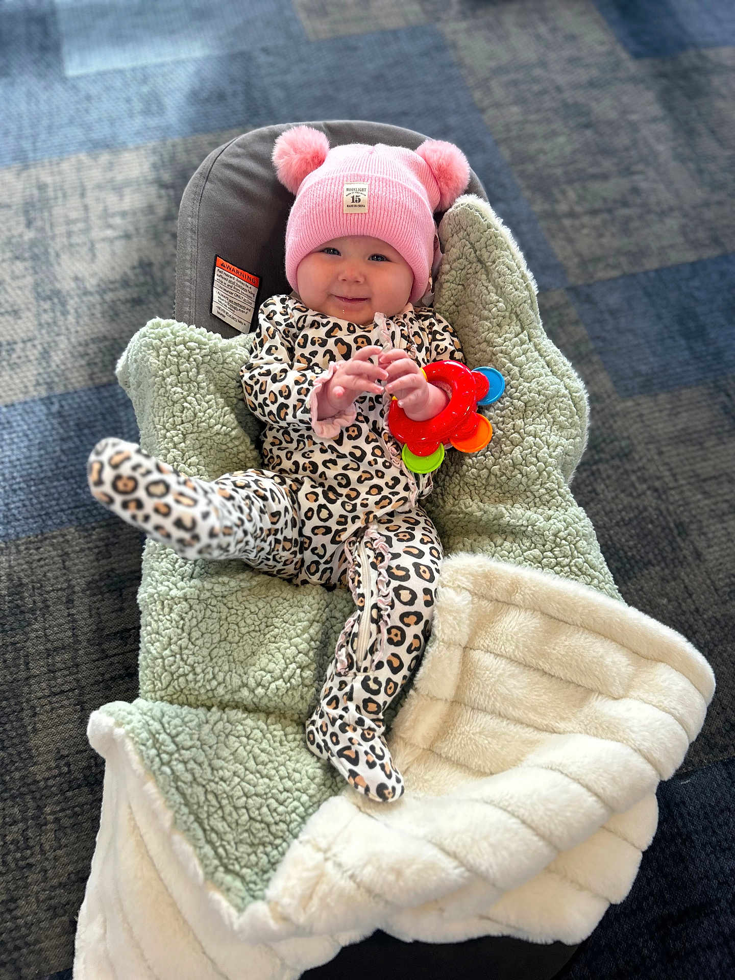 Xanova joined the competition — help win amazing prizes! baby, child, infant, smile, hat, pink, leopard_print, onesie, toy, colorful, blanket, car_seat, cozy, soft, indoor, floor, happy, cute, person, portrait