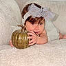 baby, child, infant, portrait, smiling, autumn, pumpkin, golden_pumpkin, bow, headband, brown_hair, blue_eyes, crawling, sitting, blanket, bed, indoors, cozy, seasonal, cute