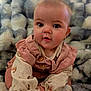 Reagan is registered to the contest to win money with this photo: baby, child, infant, face, hands, clothing, blanket, cute, sitting, soft_texture, pink, vest, patterned, cheeks, eyes, expression, indoor, portrait, young, cozy