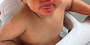 Gian is registered to the contest to win money with this photo: baby, bath, child, curious, cute, expression, eyes, face, hand, indoor, messy, mouth, person, red_stains, seat, sitting, skin, water, wet, young