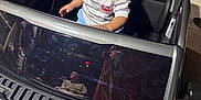 Gian is registered to the contest to win money with this photo: toddler, toy_car, child, person, outdoor, night, reflection, shirt, shorts, concrete, grass, adult, footwear, sidewalk, vehicle, window, curious, playtime, family, leisure
