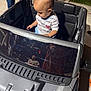 Gian is registered to the contest to win money with this photo: toddler, toy_car, child, person, outdoor, night, reflection, shirt, shorts, concrete, grass, adult, footwear, sidewalk, vehicle, window, curious, playtime, family, leisure
