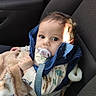 baby, pacifier, blue_jacket, blanket, car_seat, child, indoor, seatbelt, clothing, infant, person, cute, portrait, young_child, car_interior, sitting, face, head, expression, warm_clothing