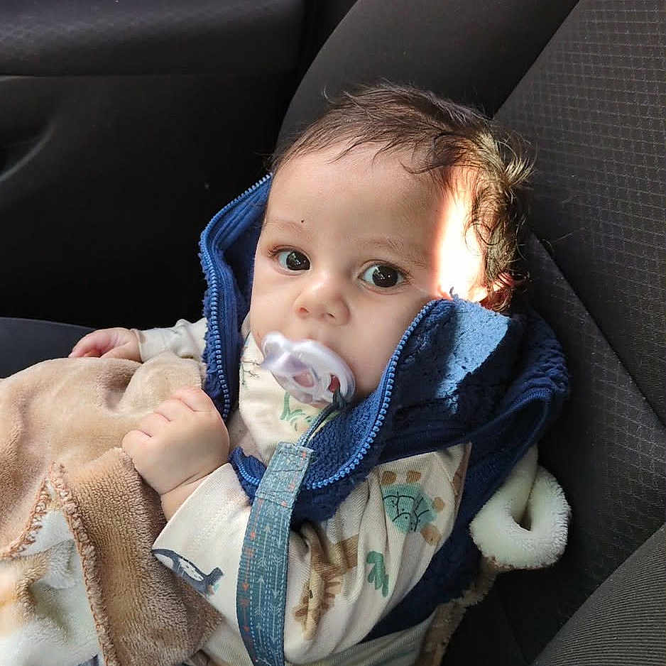 Chozen joined the competition — help win amazing prizes! baby, pacifier, blue_jacket, blanket, car_seat, child, indoor, seatbelt, clothing, infant, person, cute, portrait, young_child, car_interior, sitting, face, head, expression, warm_clothing
