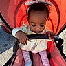 Nyuri is registered to the contest to win money with this photo: baby, child, clothing, curly_hair, fabric, grip, hand, headband, jacket, outdoor, pastel_colors, pink_pants, portrait, red_stroller, seat_belt, shadow, socks, stroller, sunlight, toddler