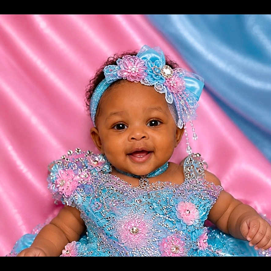 Maci is registered to the contest to win money with this photo: baby, child, portrait, smiling, dress, headband, flower, blue, pink, background, fabric, cute, happy, infant, female, studio, colorful, celebration, accessory, closeup